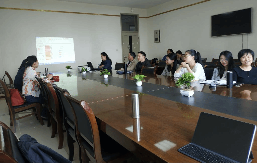 A group of people sitting at a tableDescription automatically generated with medium confidence